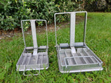 A DOC200 trap for rat, stoat, and hedgehog control sitting beside a DOC250 trap (which is bigger).
