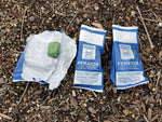 3 x filled Feratox Bio Bag bait stations for possum control - one bag is open showing bait inside.