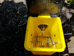 Timms trap for possum control, with a solid lure on the wire inside.