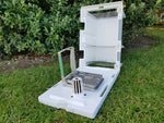 DOC200 trap for rat, stoat, and hedgehog control, sitting in plastic housing with the lid open.